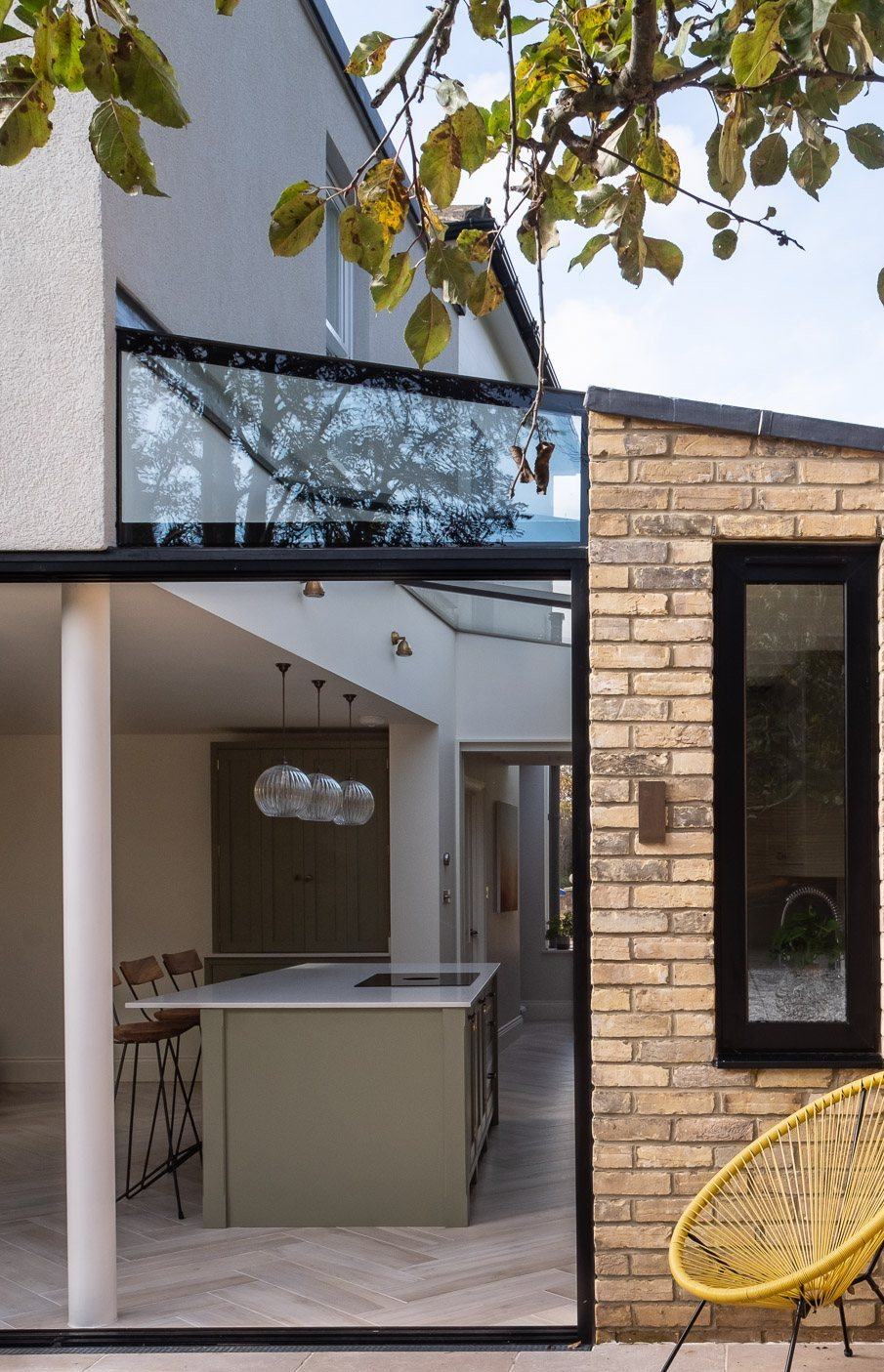 Rear extension with a glass link and sliding doors to the garden